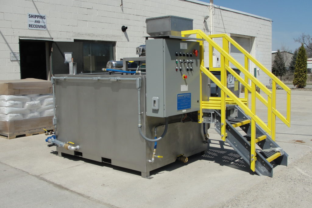 A side view of Clearwater Industries Model 300 Stainless Steel displaying it's control panel, stainless steel body and dry polymer hopper.