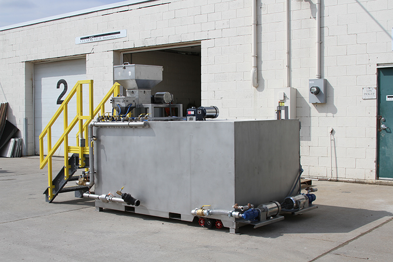 Clearwater Industries Model 500 Stainless Steel polymer make-down system pictured from the side to display it's pump system, polymer hopper and dry polymer feed system.