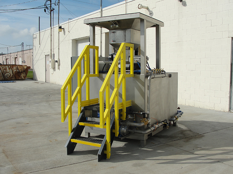 Clearwater Industries Model 300 Stainless Steel Big Bag make-down polymer system displays it's staircase and big bag pan that holds bag over the polymer hopper.