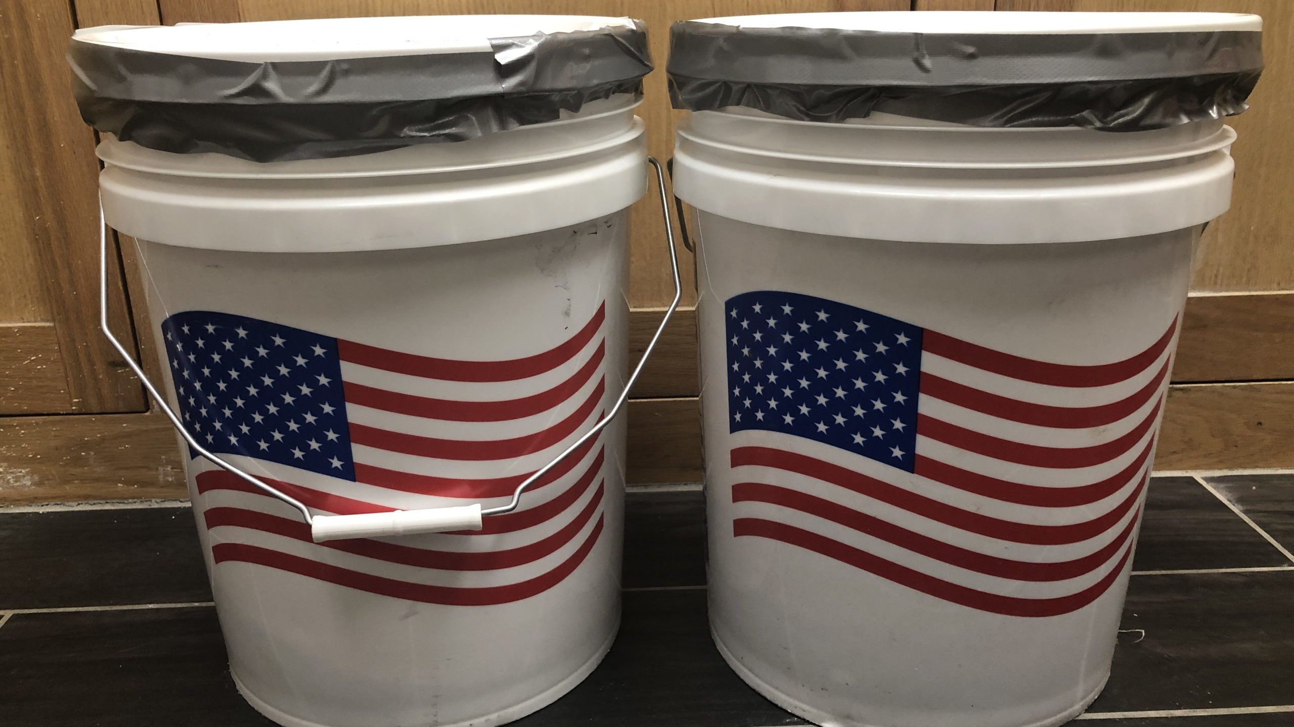 An image of two 5-gallon buckets with american flags on them.