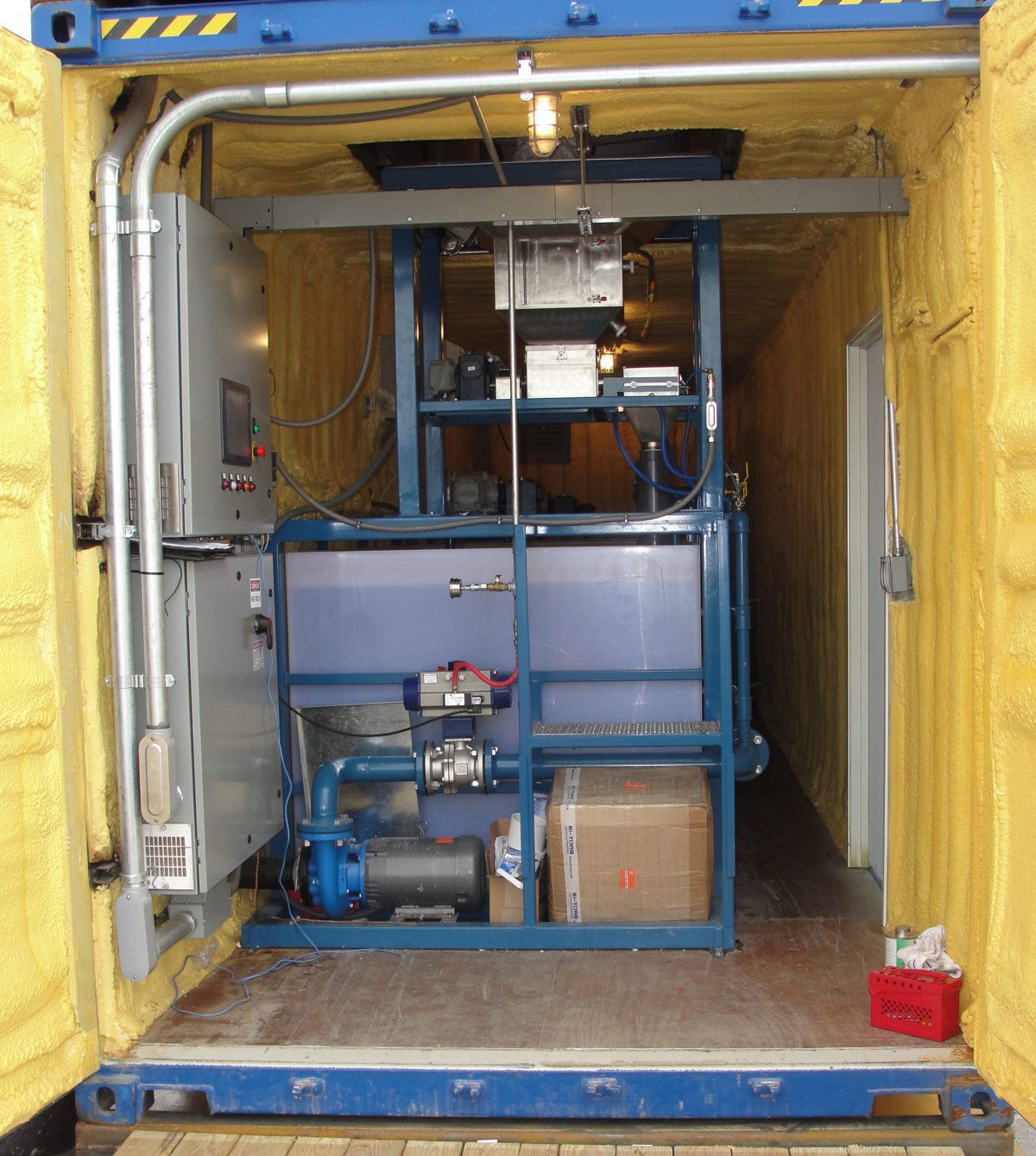 A dry polymer preparation system in spray foam insulated and climate-controlled shipping container.