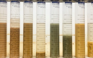 A polymer jar test picture with many different slurries being tested to show how different slurries react to polymer dosing.