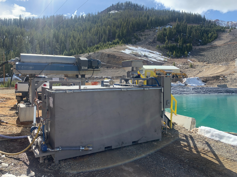 The side of a dry polymer preparation unit next to a pond at a gold mining operation.