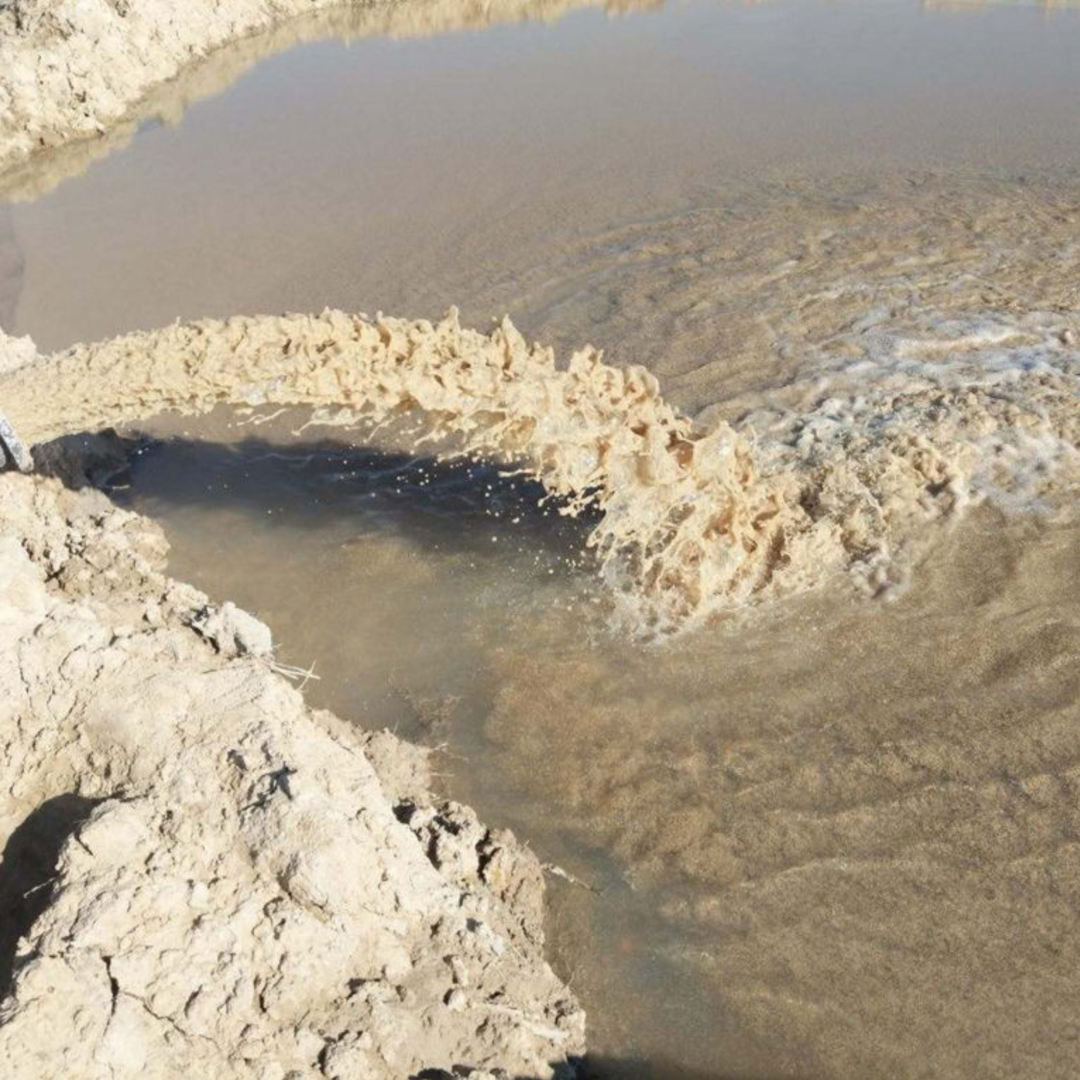 Water flowing into sand and gravel 
